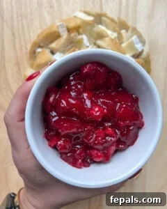 bowl of cranberry sauce over bead.