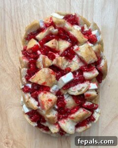 Cranberry bread is added to a sheet pan before baking.