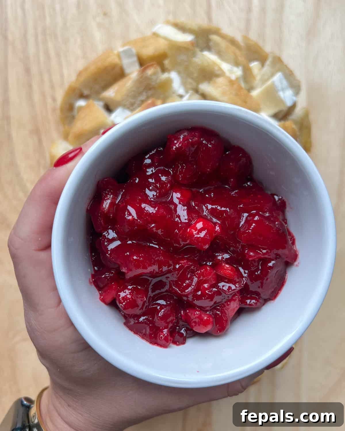 bowl of cranberry sauce over bead.