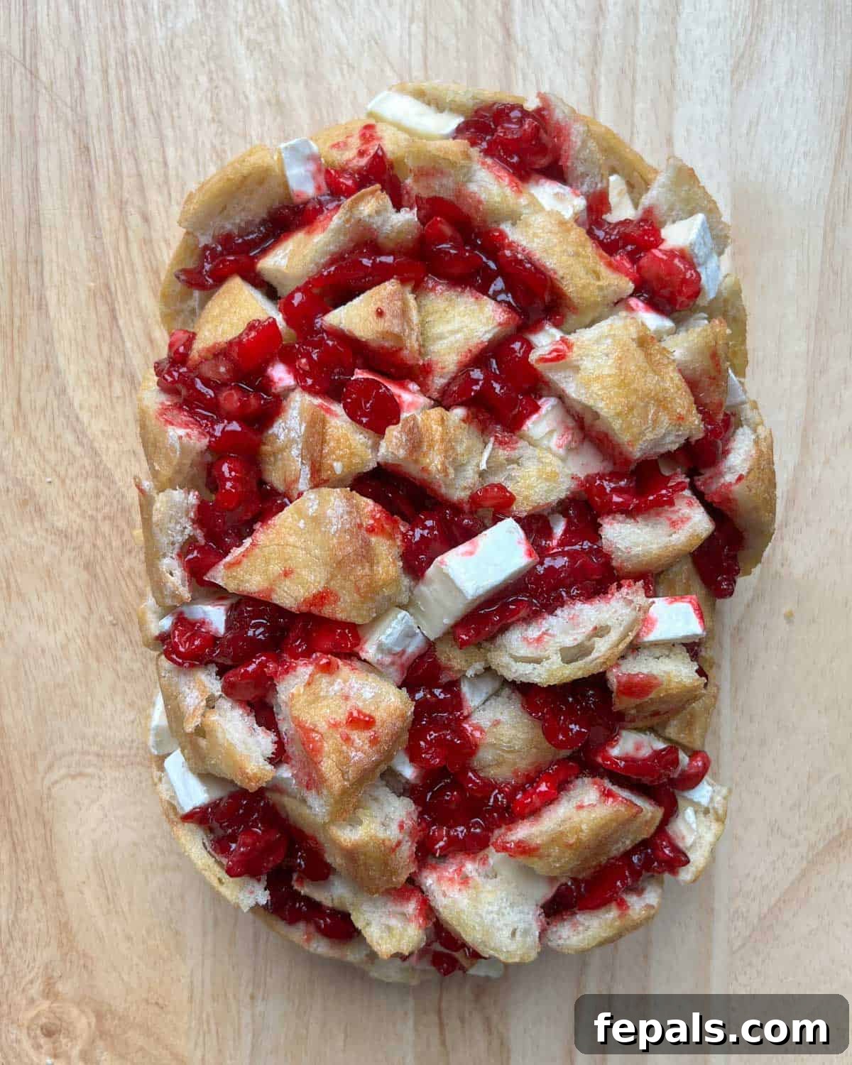 Cranberry bread is added to a sheet pan before baking.