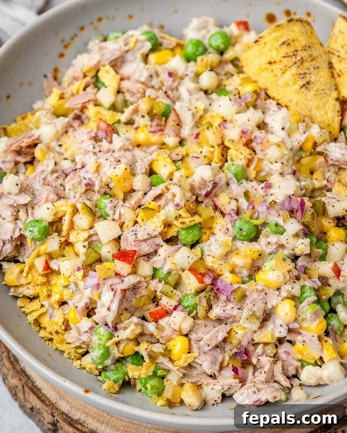 The McConaughey Tuna Salad That Broke the Internet 2 Overhead view of vibrant tuna salad featuring colorful vegetables, flaked tuna, and crunchy jalapeño chips, ready to be served.