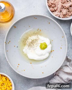 The McConaughey Tuna Salad That Broke the Internet 11 Small bowl with mayonnaise, lemon juice, white wine vinegar, wasabi, and seasoning before mixing.