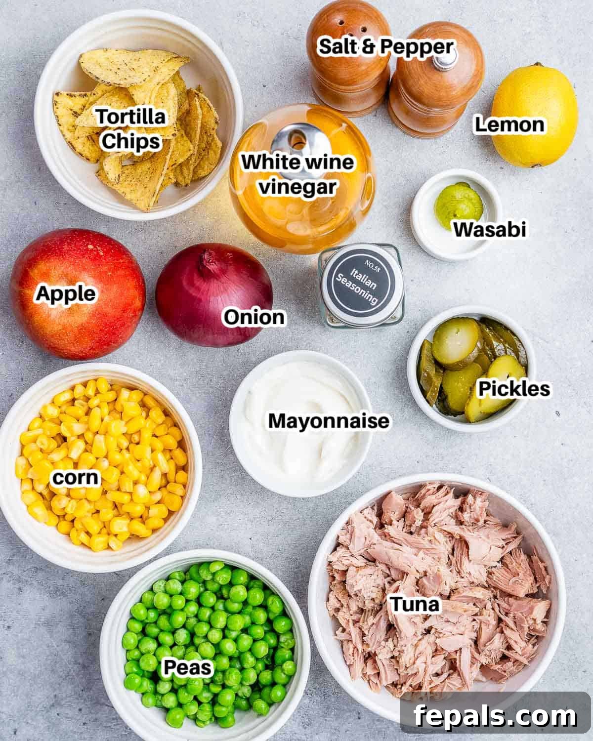 The McConaughey Tuna Salad That Broke the Internet 3 A selection of fresh ingredients laid out, including mayonnaise, white wine vinegar, lemon, wasabi paste, Italian seasoning, red onion, dill pickles, jalapeño chips, apple, canned corn, frozen peas, and canned tuna in olive oil.