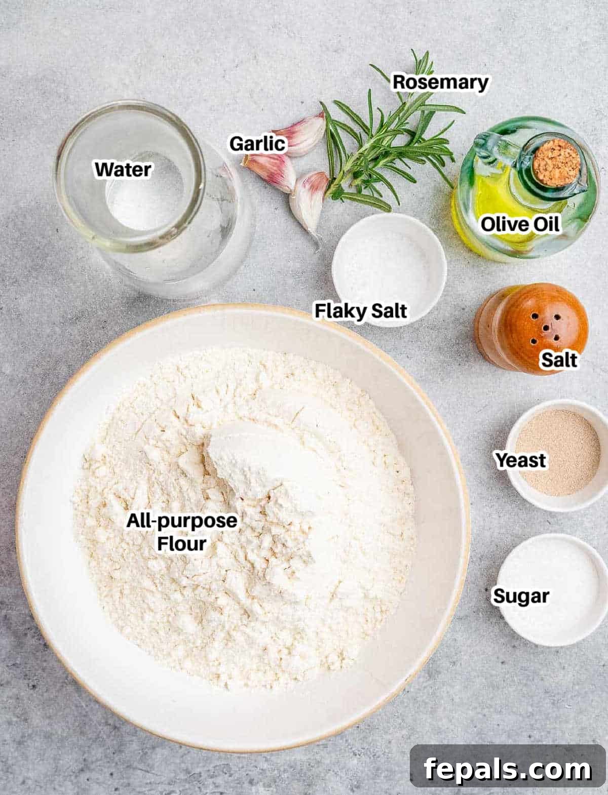 Perfect Italian Focaccia At Home 3 Fresh ingredients for Focaccia including flour, olive oil, rosemary, and garlic.