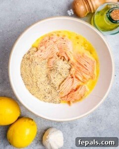 A bowl filled with ground chicken and other ingredients.
