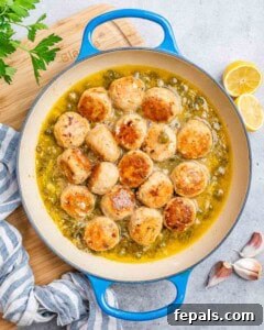 Meatballs and capers in a pot on the stove.