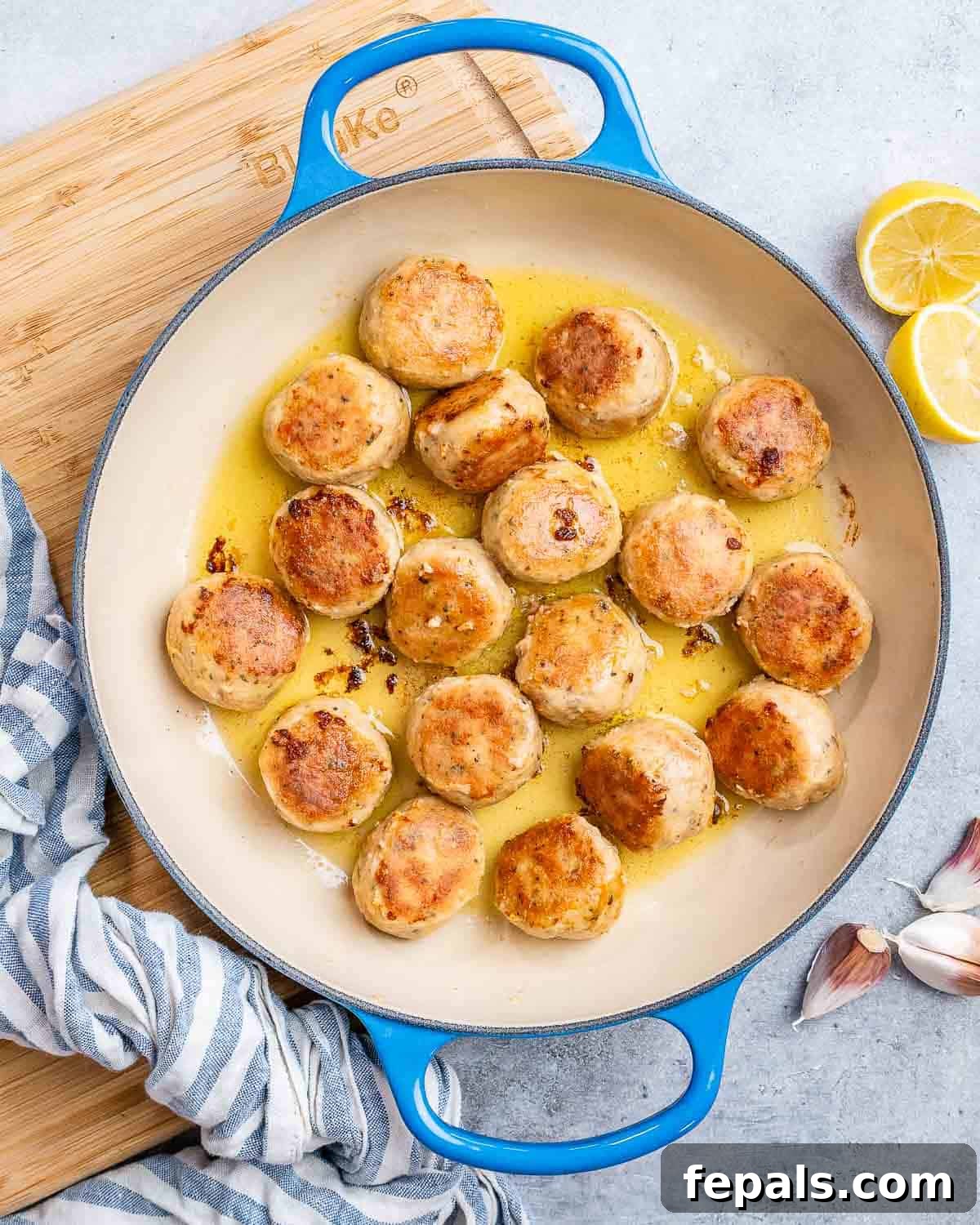 Cooking chicken meatballs in olive oil in a large pot until golden brown.