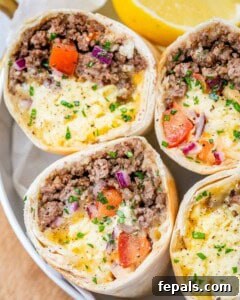 burritos sliced in half facing upwards on a plate.