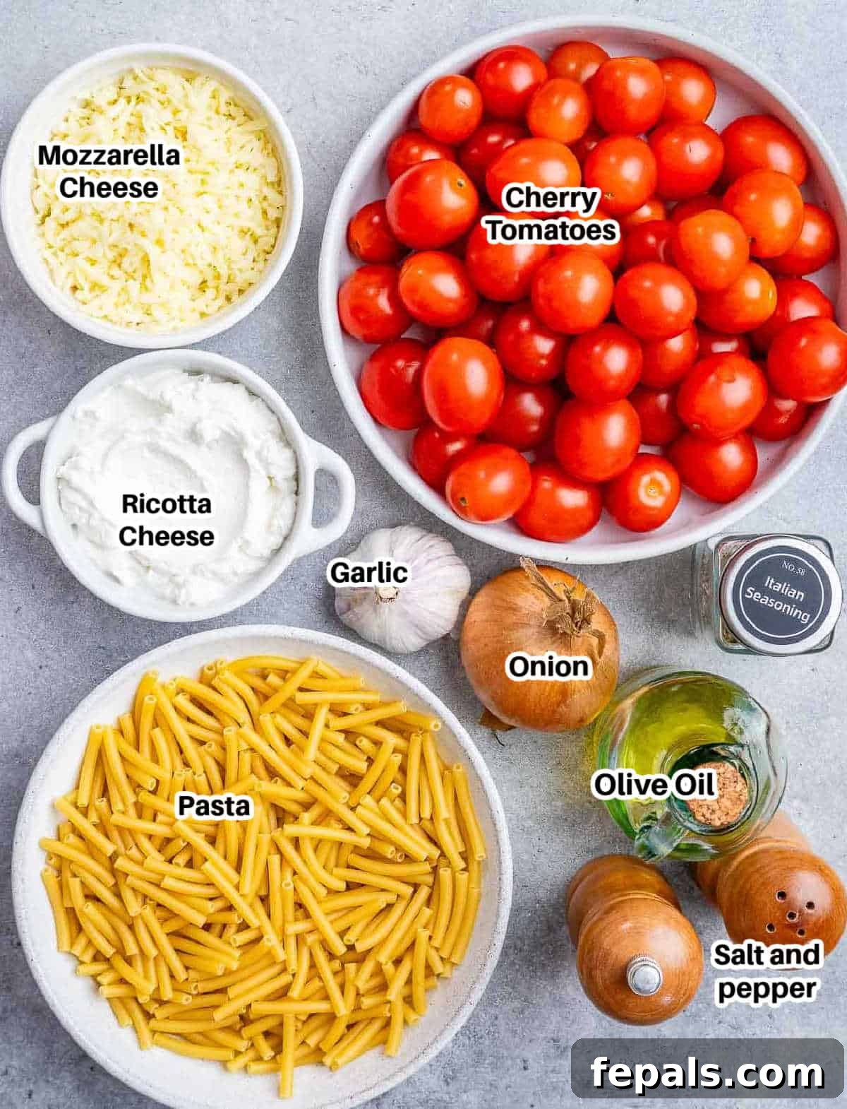 Ultimate Cheesy Baked Ziti 4 A vibrant flat lay of all the fresh ingredients needed to prepare homemade baked ziti: ziti pasta, cherry tomatoes, ricotta cheese, mozzarella cheese, onion, garlic, olive oil, and various seasonings.