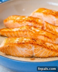Decadent Salmon Alfredo 12 Fried salmon in a blue pan.