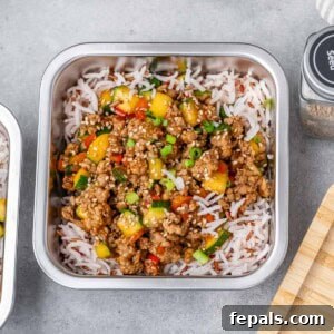 meal prep container with rice and topped with ground turkey and veggies.