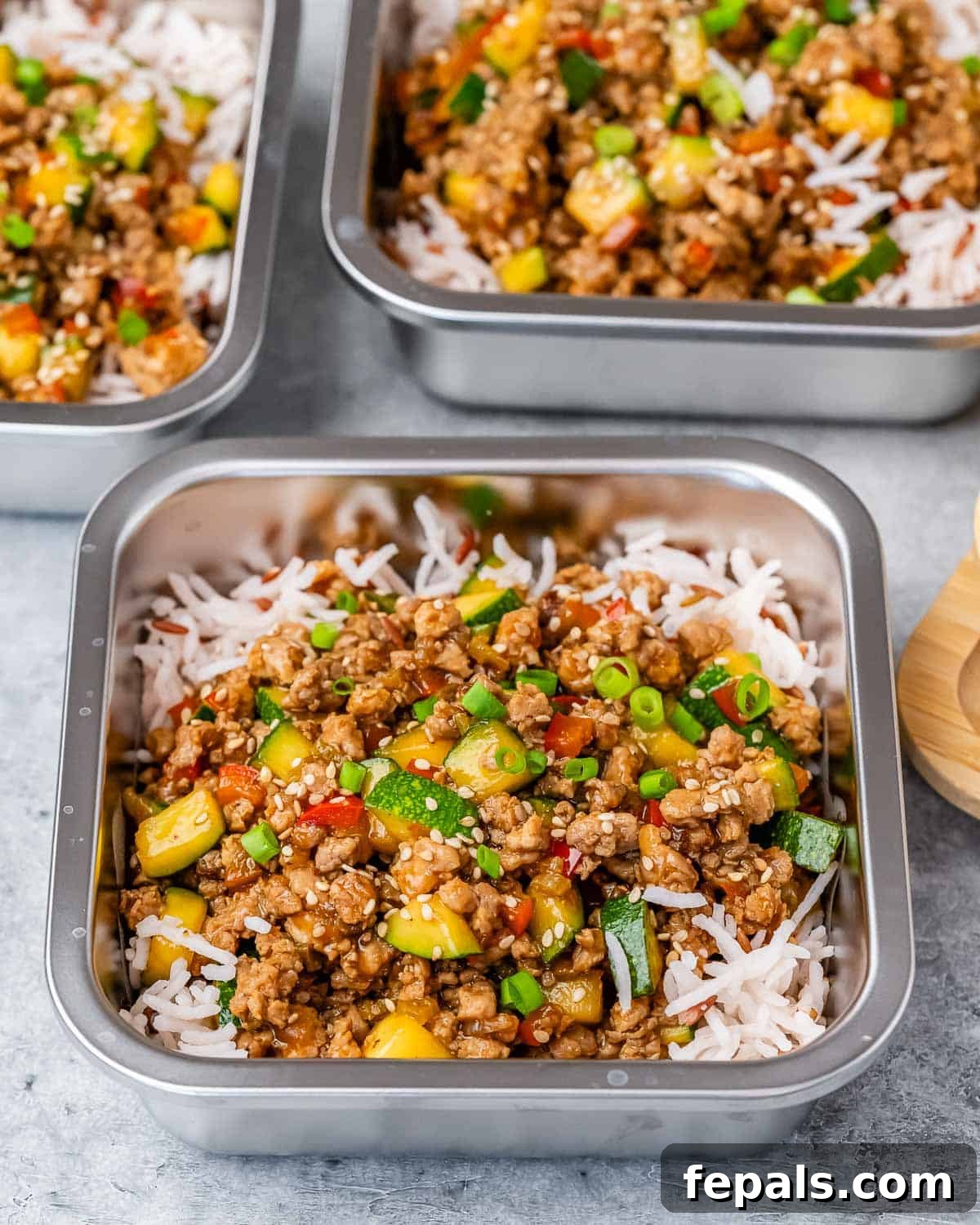 Prepped Ground Turkey Stir Fry and rice in square meal prep containers, ready for the week.