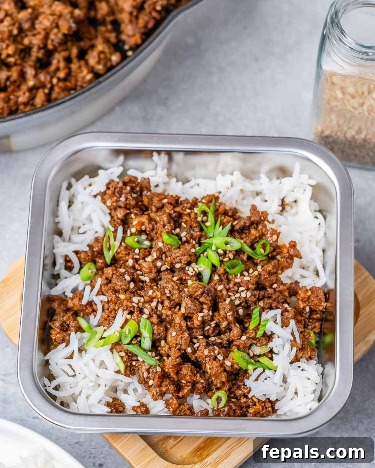 Hearty Beef & Rice Medley 3 A square container filled with rice and ground beef on top.