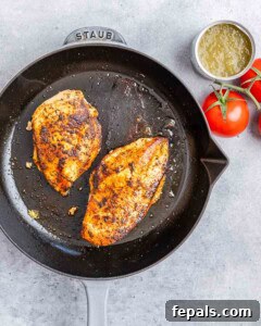 Fiesta Chicken Tostadas 12 Two cooked and seasoned chicken breasts in a skillet.