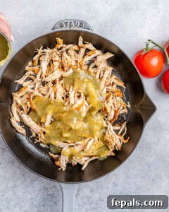 Fiesta Chicken Tostadas 13 Cooked, shredded chicken and salsa in a cast iron skillet.