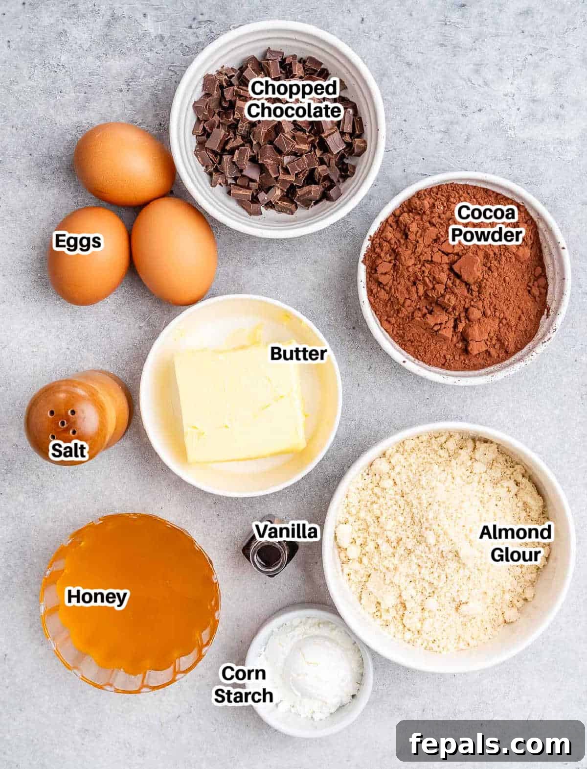 Fudgy Almond Flour Brownies 3 Ingredients laid out for making almond flour brownies, including flour, cocoa, butter, honey, and chocolate chips.
