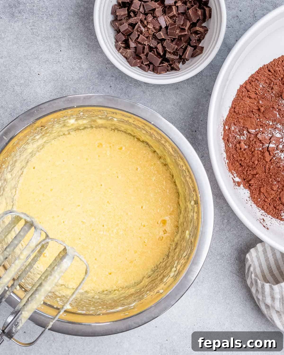 Fudgy Almond Flour Brownies 5 Wet ingredients (butter, honey, vanilla, eggs) being whisked together in a separate bowl until creamy.