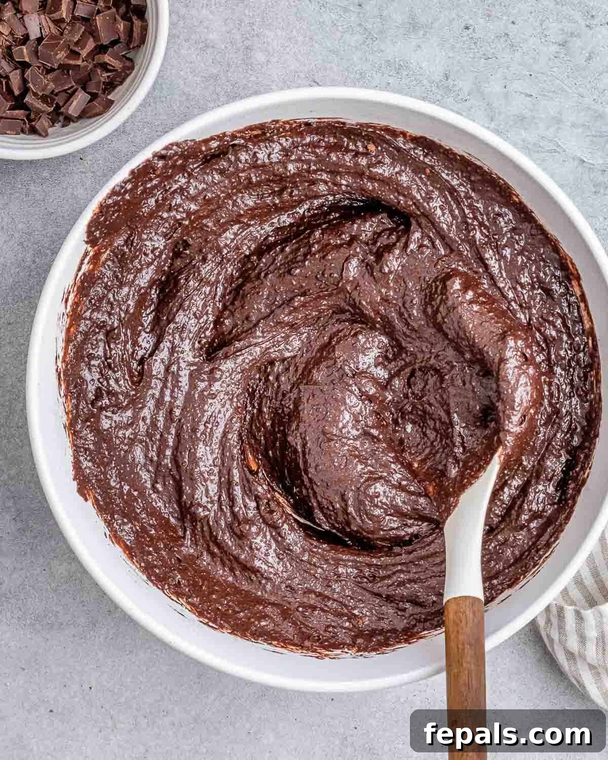 Fudgy Almond Flour Brownies 6 The dry flour mixture being added to the wet egg mixture and gently stirred with a spatula.