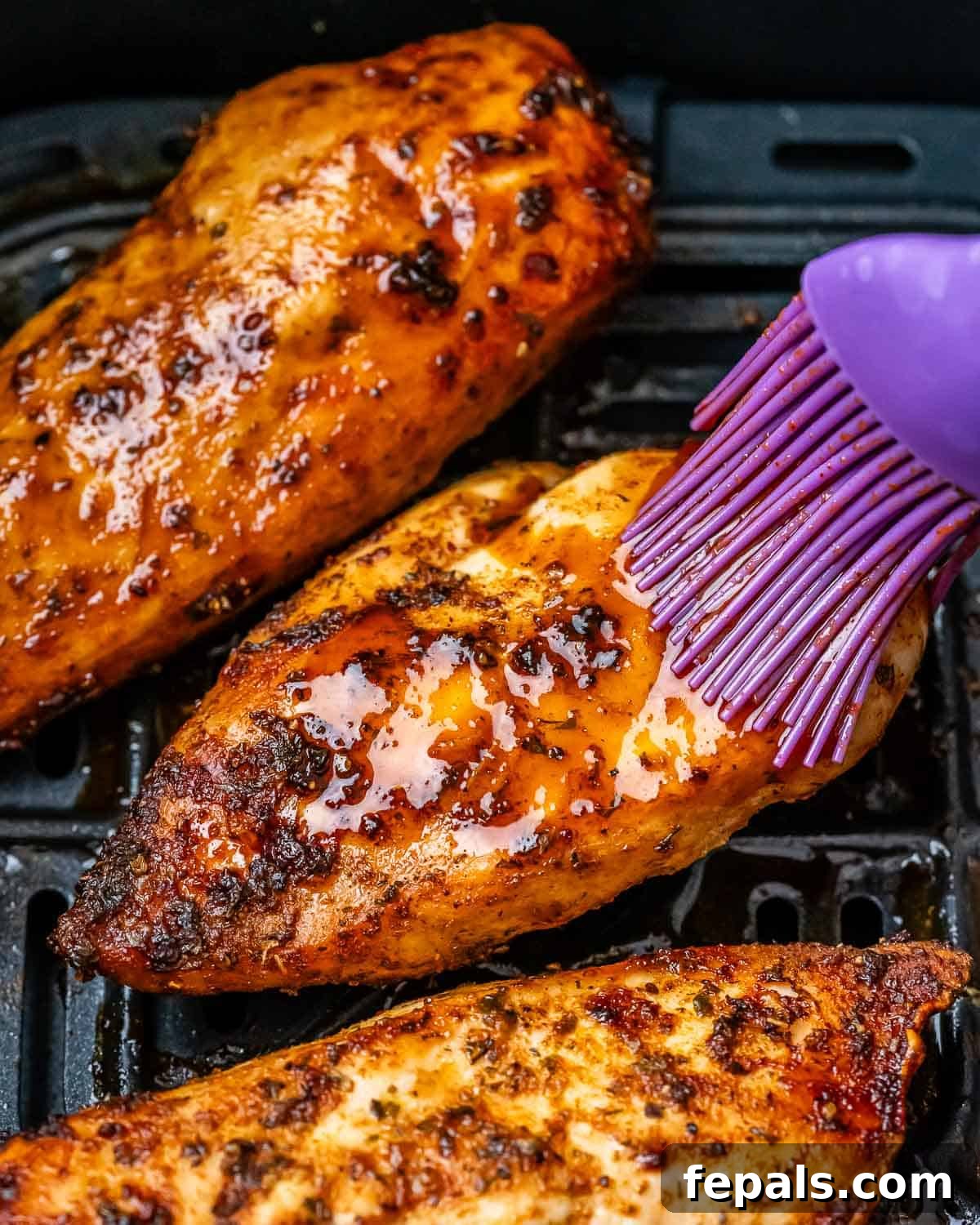 Air Fryer Frozen Chicken Breast Magic 7 Brushing the tops of chicken with glaze.