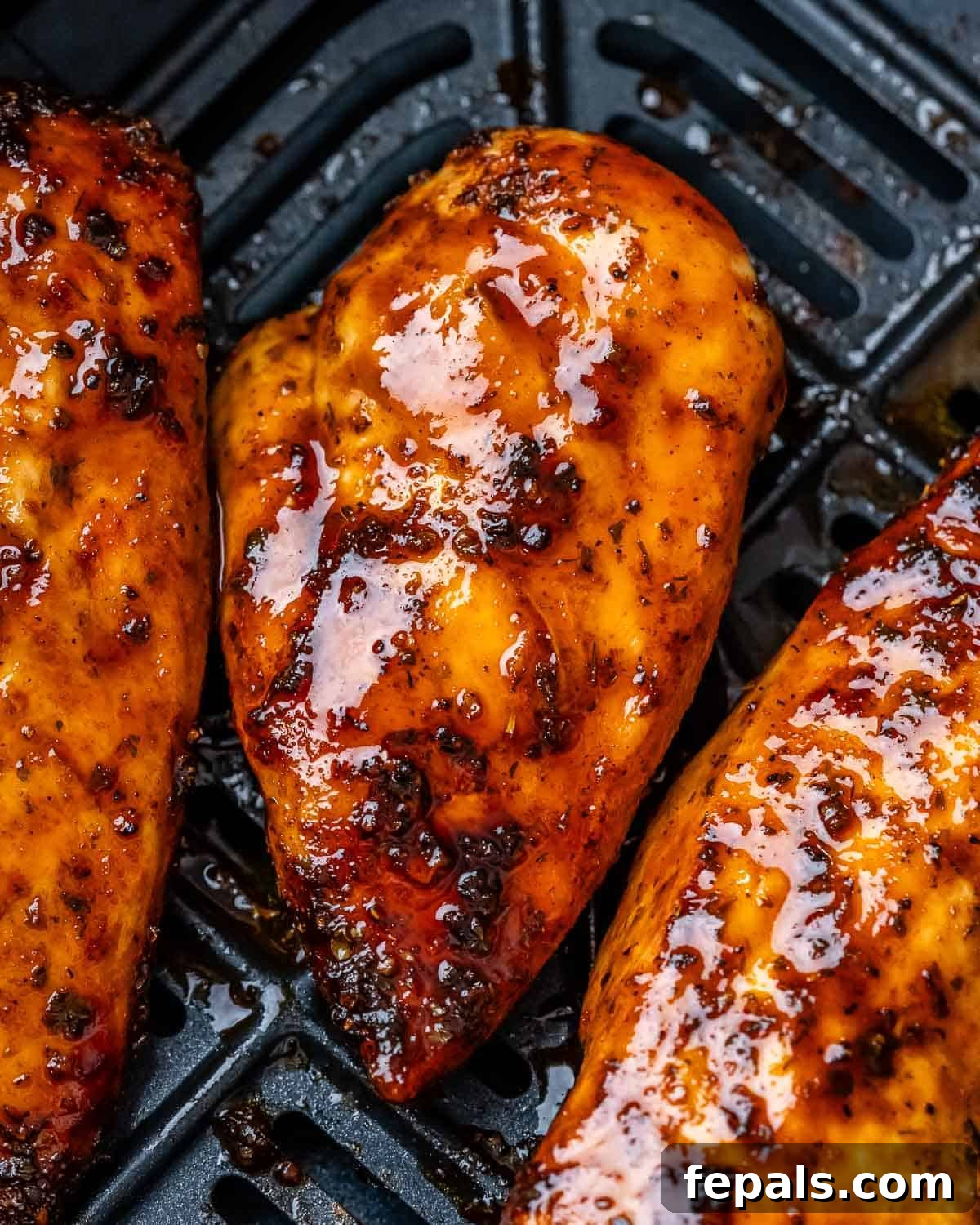 Air Fryer Frozen Chicken Breast Magic 8 Three chicken glazed breasts in an air fryer.