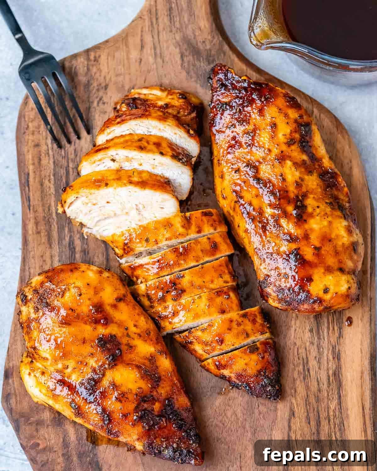 Air Fryer Frozen Chicken Breast Magic 9 Sliced chicken breasts on a cutting board.