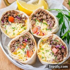 Four breakfast burrito halves in a bowl, showcasing a hearty and portable morning meal.