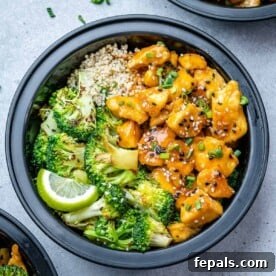 A top-down view of vibrant honey chicken, accompanied by tender broccoli florets and fluffy quinoa, all perfectly arranged in a convenient meal prep bowl.