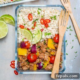 A savory ground turkey and cauliflower rice skillet recipe neatly packed into a clear glass container, showcasing a healthy and convenient meal option.