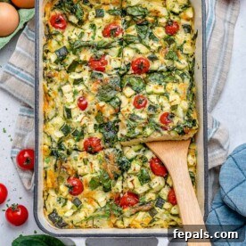A generous portion of baked eggs and vegetables elegantly served on a spatula, showcasing a healthy and easy meal option.