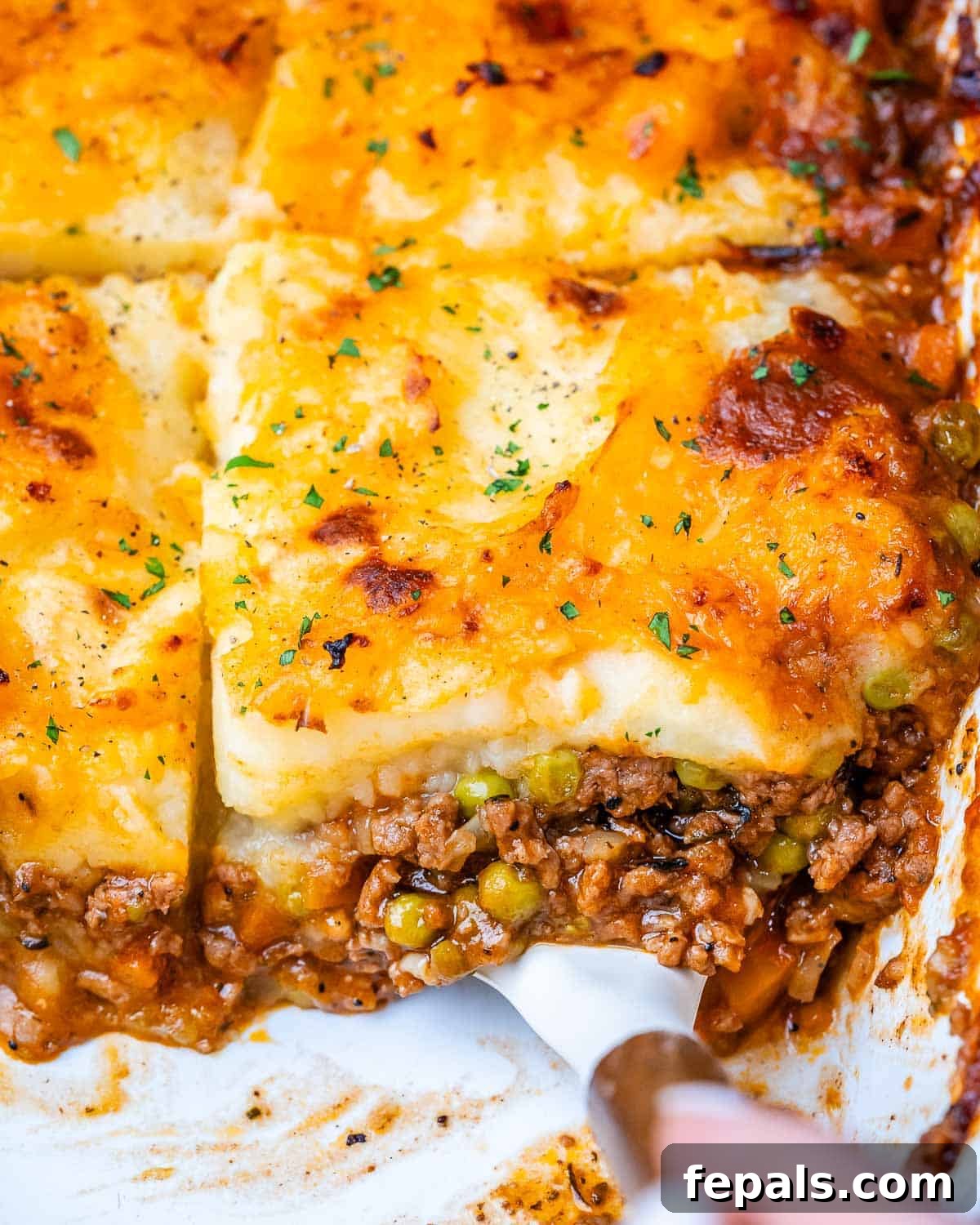 Homestyle Beef Shepherd's Delight 2 Shepherds pie in a white baking dish with meat showing at the bottom and potatoes on top.