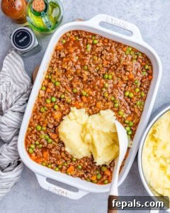 Homestyle Beef Shepherd's Delight 16 A white casserole dish. with a dollop of potatoes on top.