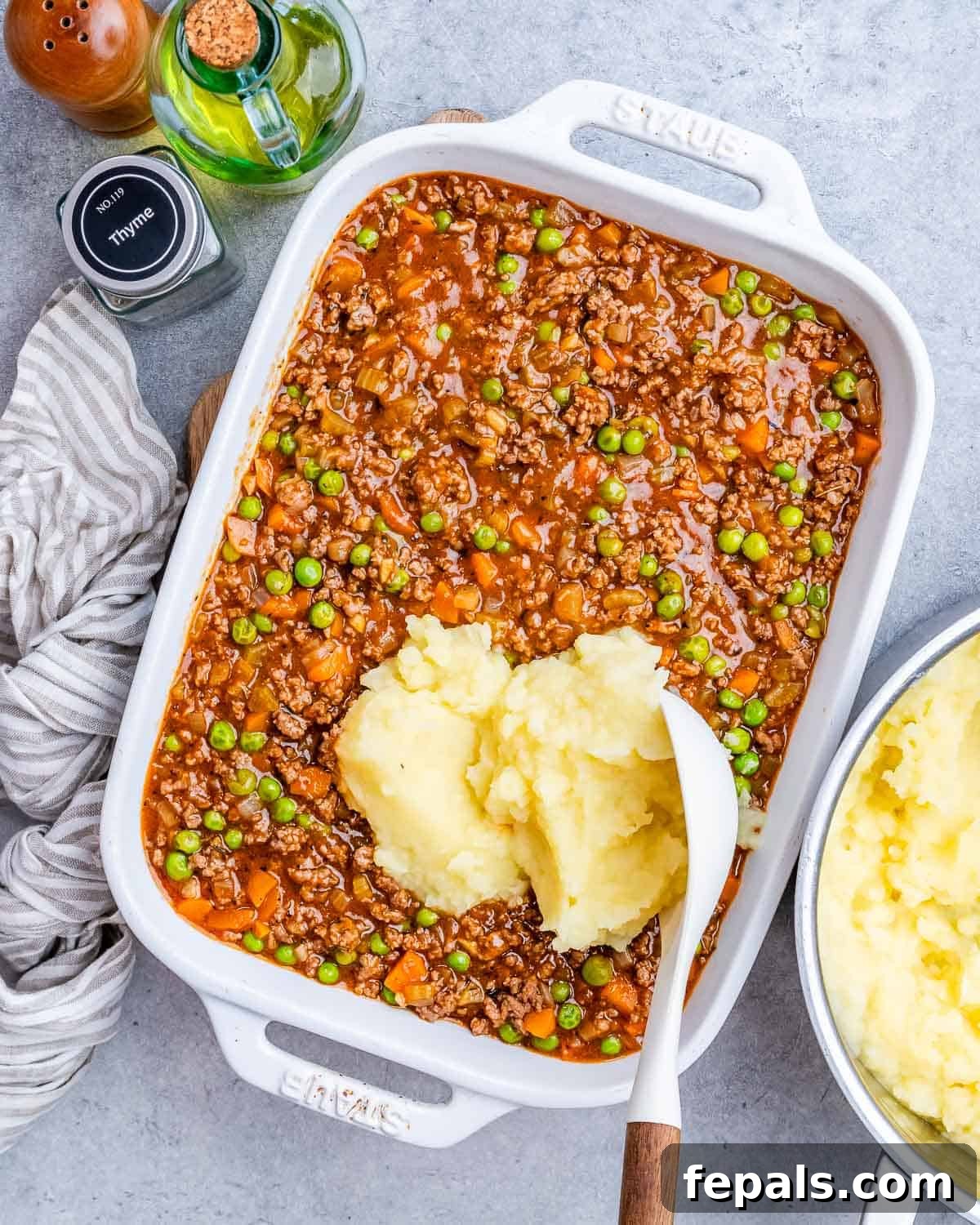 Homestyle Beef Shepherd's Delight 8 A white casserole dish. with a dollop of potatoes on top.