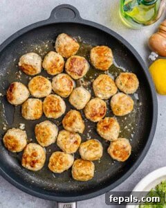 Cooked meatballs in a cast iron skillet.
