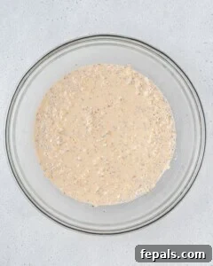 Oats mixed with milk and yogurt in a bowl.