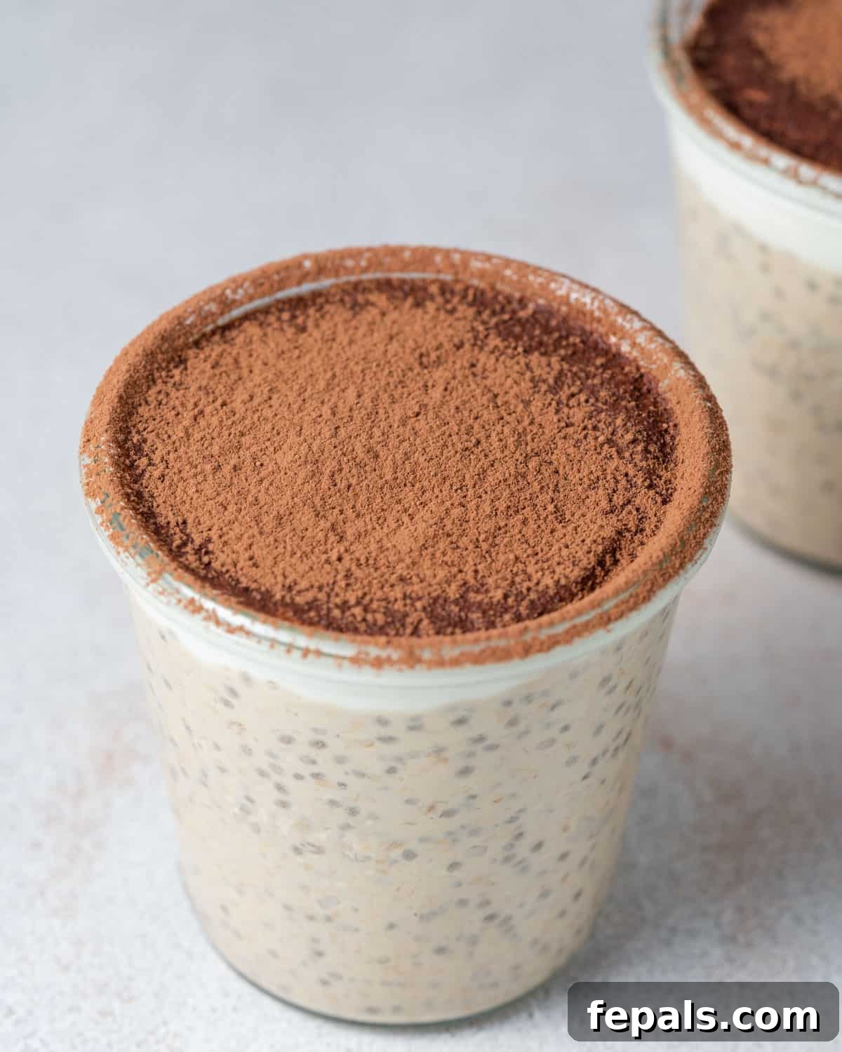 Creamy Tiramisu Overnight Oats 7 A single jar of Tiramisu Overnight Oats, perfectly topped with cocoa powder, ready to be enjoyed.