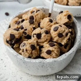 edible cookie dough balls in a white bowl.