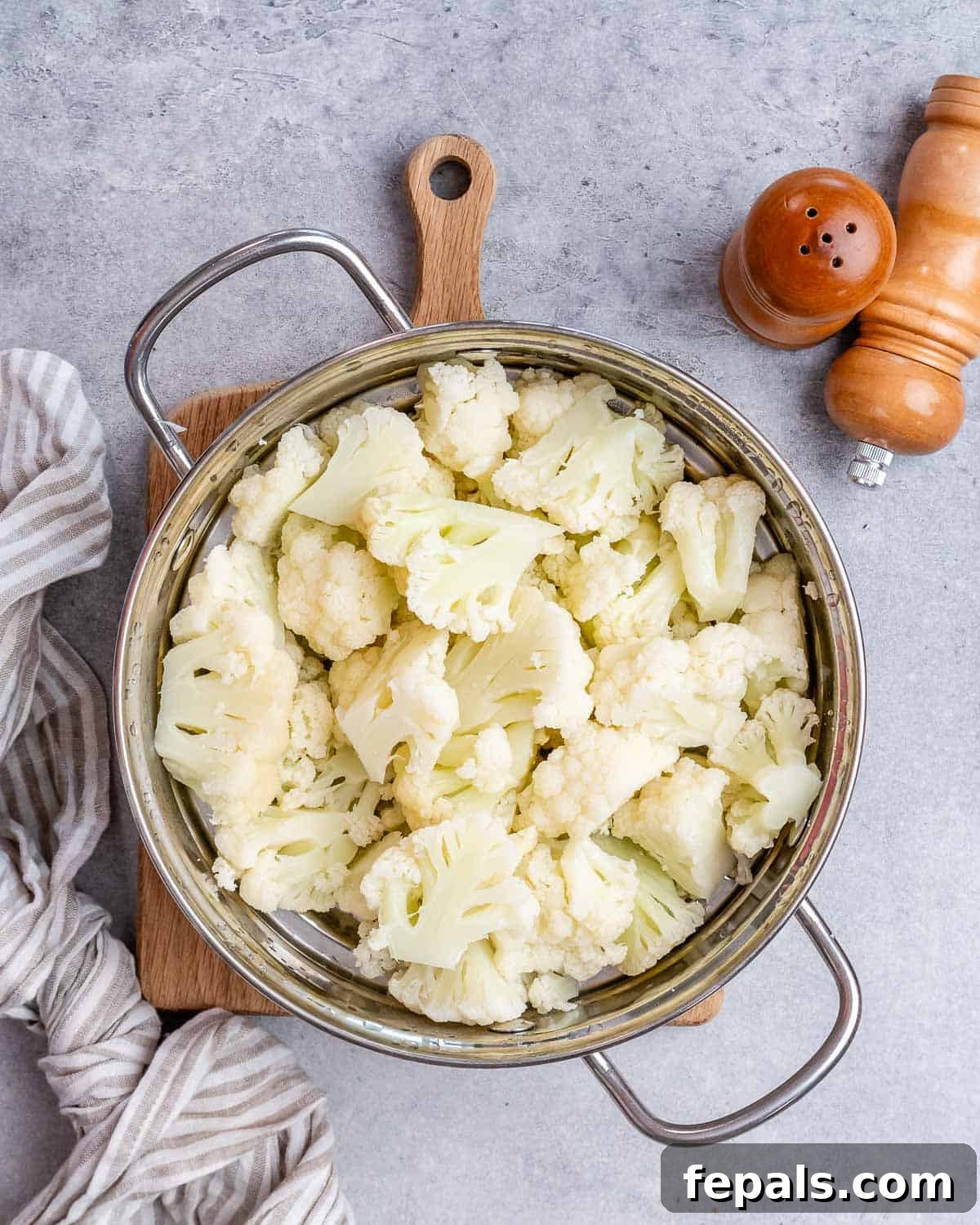 Chopped cauliflower in a steel pot.