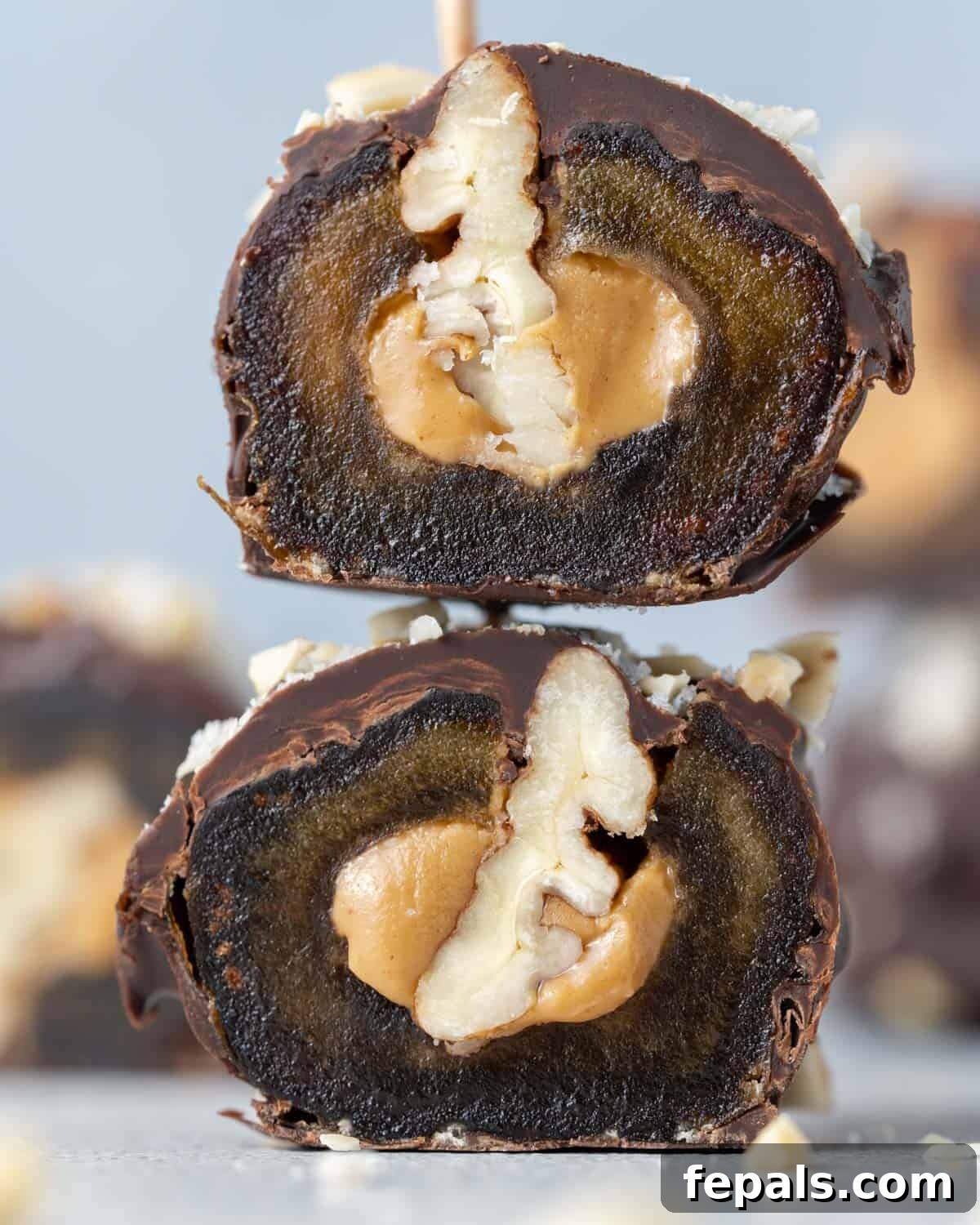 Another halved date Snickers, zoomed in to highlight the rich layers of date, peanut butter, and pecan