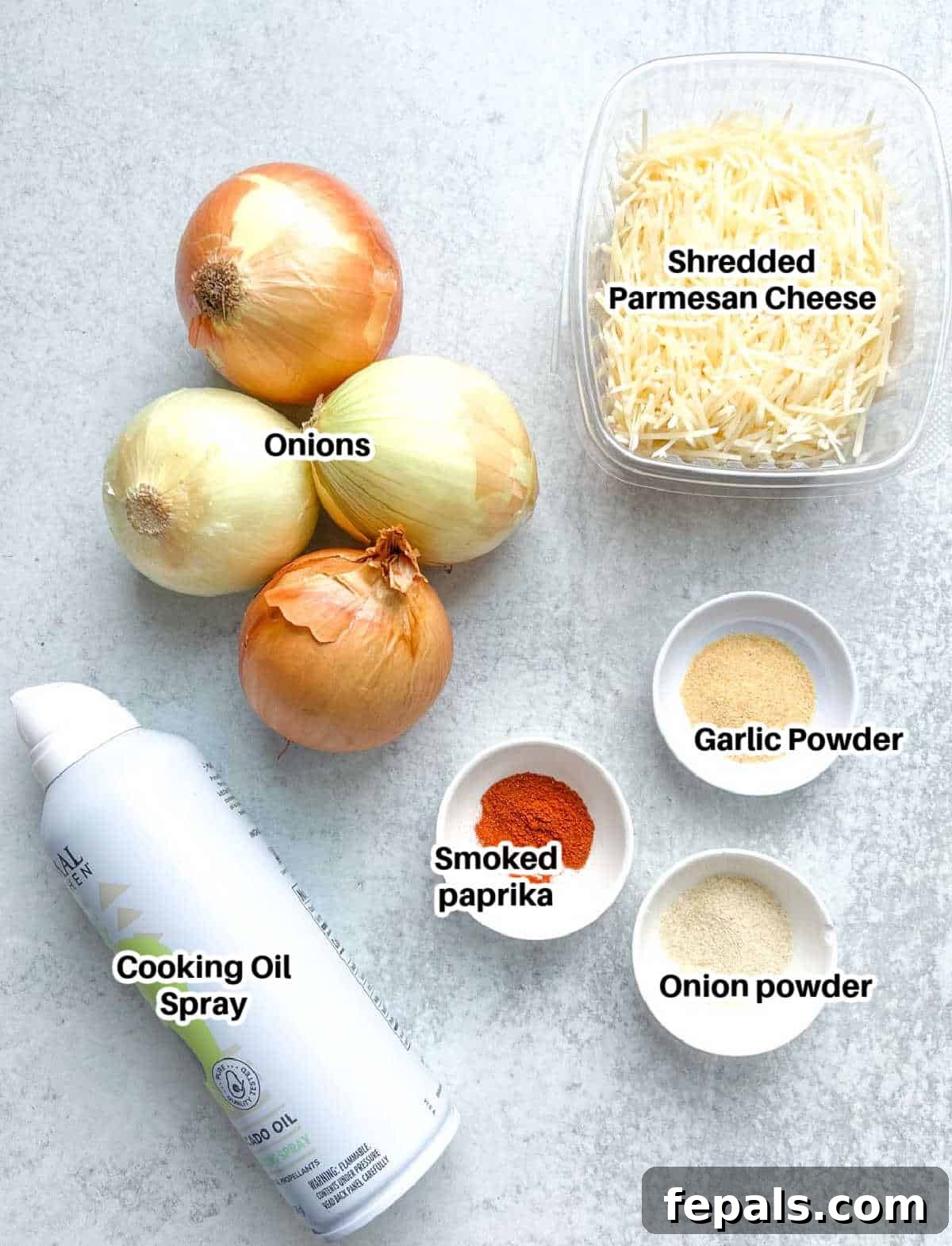 Golden Crunch Onion Rings 3 A flat lay image displaying all the ingredients needed to make low-carb onion ring chips: onions, shredded parmesan cheese, and a selection of seasonings.