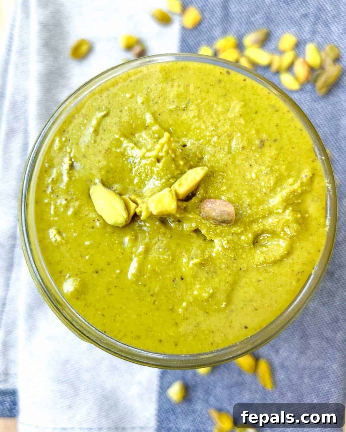 Decadent Pistachio Cream 2 A beautiful jar filled with vibrant green homemade pistachio cream, ready to be enjoyed.