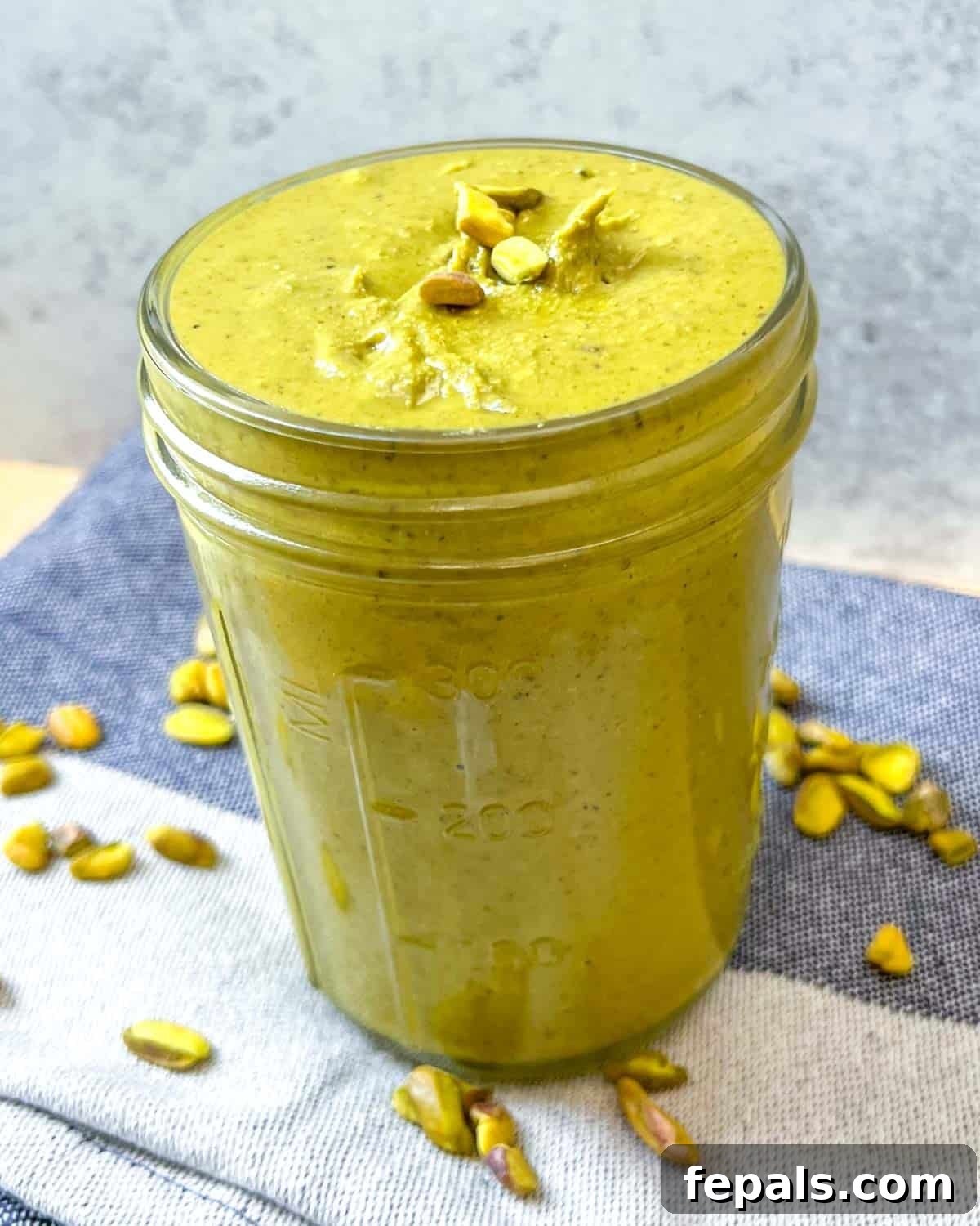 Decadent Pistachio Cream 11 A jar of homemade pistachio cream, showcasing its rich, creamy texture and inviting green color.