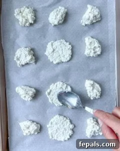 Crispy Cottage Cheese Bites 12 spoon adding cottage cheese on pan.