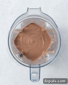 Blended chocolate mousse inside a blender jar with visible swirls of creaminess.