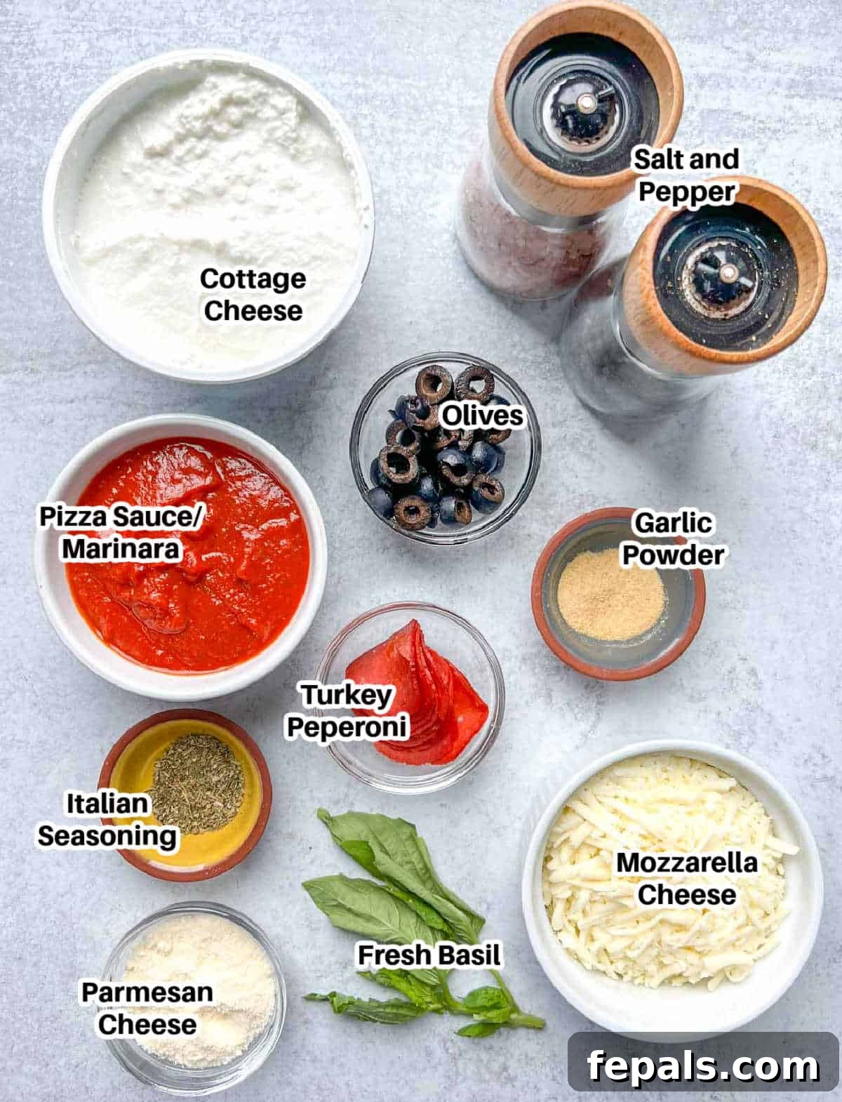 Crustless Pizza Cottage Bowl 3 Various ingredients for cottage cheese pizza bowl including cottage cheese, marinara sauce, cheese, olives, pepperoni, and spices.