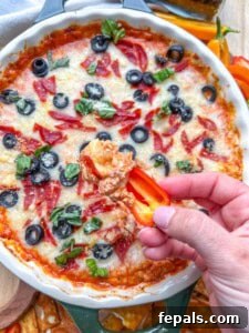 Crustless Pizza Cottage Bowl 20 hand holding a mini bell pepper and dipping in pizza bow.