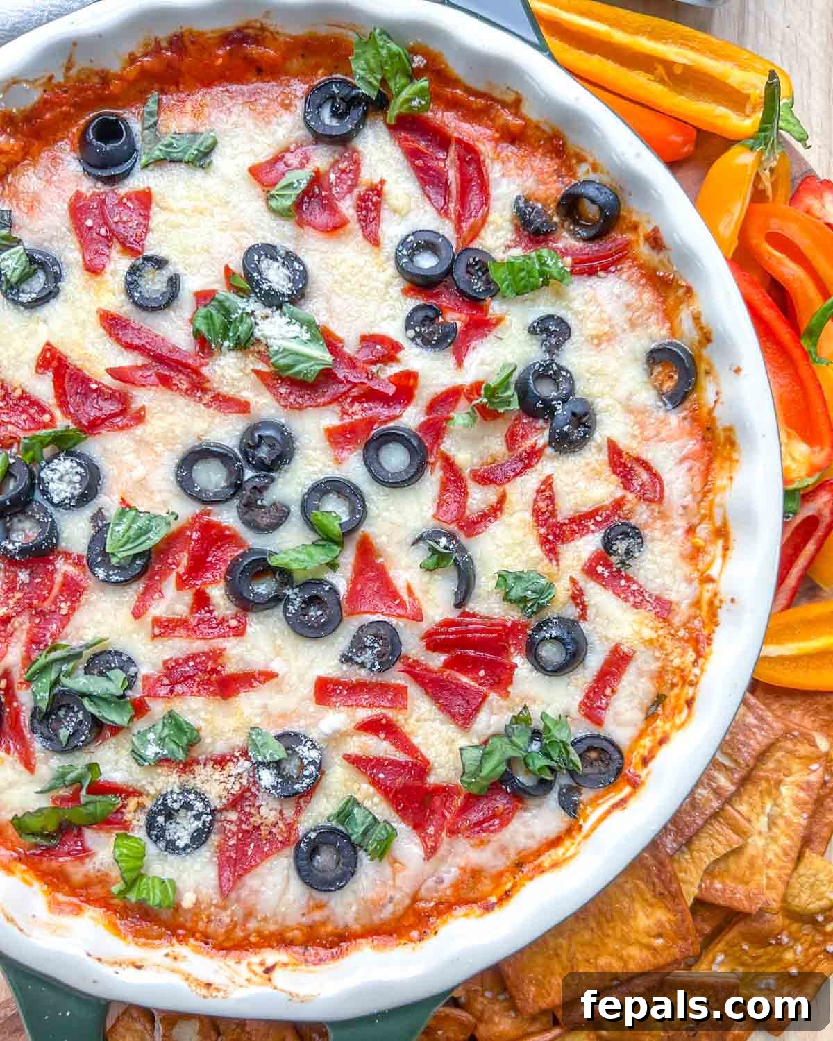 Crustless Pizza Cottage Bowl 8 a round bowl with bake cottage cheese pizza next to bell peppers and chips.