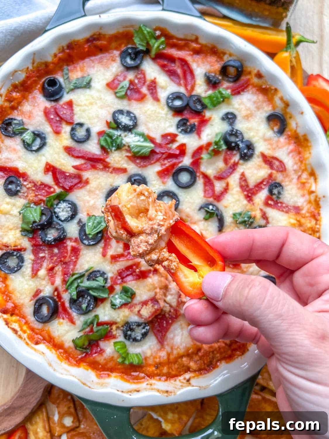 Crustless Pizza Cottage Bowl 9 hand holding a mini bell pepper and dipping in pizza bow.
