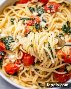 fork grabbing a portion of spaghetti from skillet.