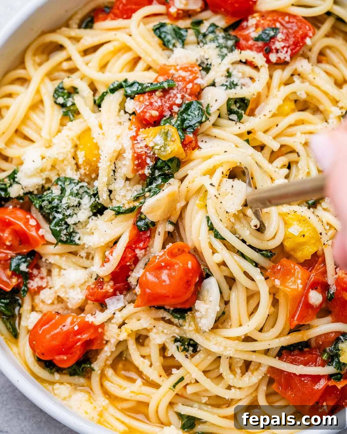 fork grabbing pasta from skillet. 
