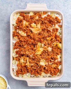 Easy Cabbage Roll Bake 13 A casserole dish tightly covered with aluminum foil, ready for its initial bake in the oven to ensure even cooking and moisture retention.